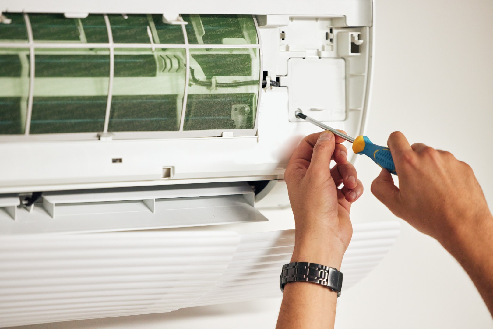 Technicien entretenant les filtres d'un climatiseur sud ouest